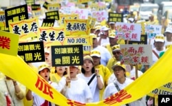 Tourism-related business workers shout slogans during a march in Taipei, Taiwan, Monday, Sept. 13, 2016. (File, AP/Chiang Ying-ying)