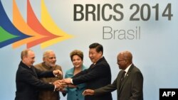 Brazil -- Leaders of the BRICS join their hands during the official photograph of the 6th BRICS summit in Fortaleza, July 15, 2014