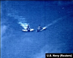 AT SEA -- A surveillance photo shows the Russian naval destroyer Admiral Vinogradov making what the U.S. Navy describes as an unsafe maneuver against the Ticonderoga-class guided-missile cruiser USS Chancellorsville in the Philippine Sea, June 7, 2019
