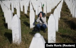 BOSNIA-HERZEGOVINA -- A woman reacts near a grave of her family members in the Memorial center Potocari near Srebrenica, November 22, 2017