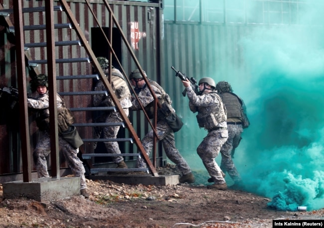 Latvian Army soldiers practice urban fighting during Silver Arrow 2017 multinational military drills involving eleven NATO members in Adazi, Latvia October 29, 2017.