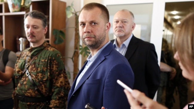 UKRAINE – Alexander Borodai, center, Prime Minister of the self proclaimed 'Donetsk people's republic', listens for a question during his and Igor Strelkov, a pro-Russian separatist commander, left, news conference in Donetsk, July 12, 2014