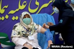 A member of the Imam Khomeini Hospital medical personnel receives a dose of Russia’s Sputnik V vaccine against the coronavirus disease (COVID-19), in Tehran, Iran on Tuesday, Feb. 9, 2021.