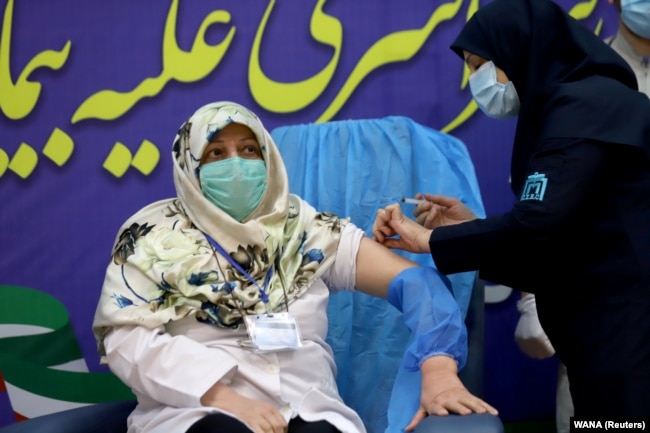 A member of the Imam Khomeini Hospital medical personnel receives a dose of Russia’s Sputnik V vaccine against the coronavirus disease (COVID-19), in Tehran, Iran on Tuesday, Feb. 9, 2021.