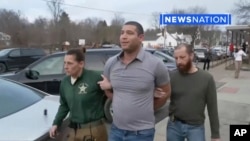 This image taken from video provided by Newsnation/TMX shows reporter Evan Lambert being taken into police custody on Wednesday, Feb. 8, 2023 in East Palestine, Ohio. (NewsNation TMX via AP)