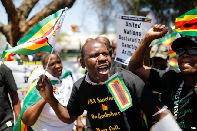 Members of the World Wide Forum for Economic Development gather to picket against sanctions imposed by the US on Zimbabwe at the US Embassy in Pretoria on October 25, 2023. (Phill MAGAKOE / AFP)