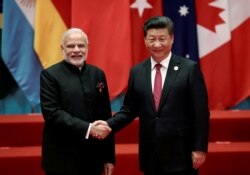 Chinese President Xi Jinping (R) shakes hands with Indian Prime Minister Narendra Modi during the G20 Summit in Hangzhou, Zhejiang province, China on September 4, 2016.