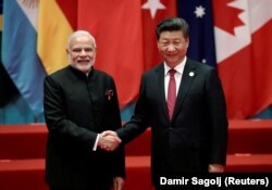 Chinese President Xi Jinping (R) shakes hands with Indian Prime Minister Narendra Modi during the G20 Summit in Hangzhou, Zhejiang province, China on September 4, 2016.