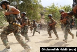 Afghan soldiers take positions in Achin district of eastern Nangarhar province, where Afghan and U.S. security forces are conducting an operation against the IS militants, August 18, 2017