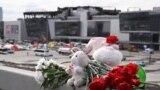 Flowers and toys left at the side of a road near the burnt-out Crocus City Hall concert venue in Krasnogorsk, outside Moscow, on March 26, 2024. (Natalia Kolesnikova/AFP)