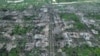 Residential buildings razed to the ground and shell craters are seen on an aerial view of Maryinka, an eastern city where heaviest battles with the Russian troops have been taking place in the Donetsk region, Ukraine, Thursday, May 11, 2023. (AP Photo/Libkos)