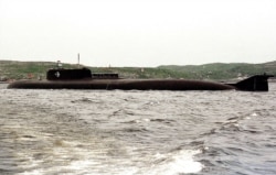 The crew of the Kursk nuclear submarine lines up on the vessel's deck, June 30, 2000, before the training exercise during which the accidental explosion occurred.