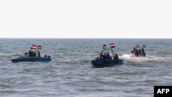 Members of the Yemeni Coast Guard affiliated with the Houthi group patrol the sea as demonstrators march through the Red Sea port city of Hodeida in solidarity with the people of Gaza on January 4, 2024. (AFP)