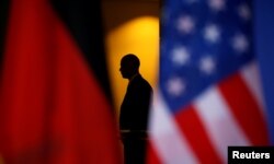 A member of a security detail keeps watch as President Barack Obama and Chancellor Angela Merkel meet in the German Chancellery in Berlin, Germany on November 17, 2016.