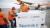 Workers take care of the shipment of Russia's Sputnik V vaccine at the airport, in Caracas, on March 29, 2021. 