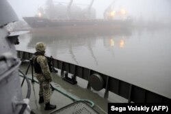 UKIRAINE -- Ukrainian soldier stands guard aboard a military boat called the "Dondass" moored at Mariupol, Sea of Azov port, November 27, 2018.