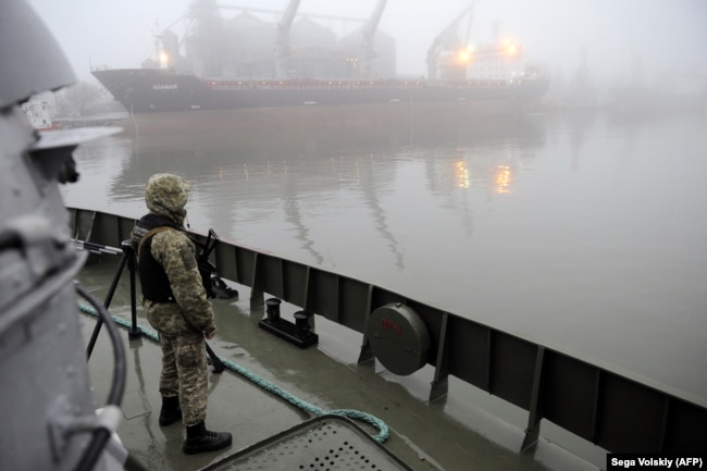 UKIRAINE -- Ukrainian soldier stands guard aboard a military boat called the "Dondass" moored at Mariupol, Sea of Azov port, November 27, 2018.