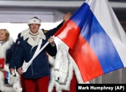 RUSSIA -- Aleksandr Zubkov of Russia carries the national flag as he leads the team during the opening ceremony of the 2014 Winter Olympics in Sochi, February 7, 2014