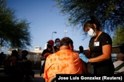 A healthcare worker from the El Paso Fire Department administers the Moderna vaccine against the COVID-19 at a vaccination center in El Paso, Texas, on May 7, 2021. (Jose Luis Gonzalez/Reuters)