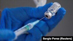 A nurse fills a syringe with a second dose of the Pfizer-BioNTech COVID-19 vaccine, in Madrid, on February 4, 2021.