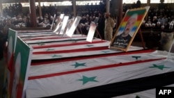 SYRIA - A handout picture released by the official Syrian Arab News Agency (SANA) shows coffins lined up during a mass funeral of yesterday's suicide attacks victims in the southern city of Suwayda on July 26, 2018.