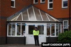 U.K. -- Police officers are seen outside Amesbury Baptist Centre in Amesbury, nine miles north of Salisbury, southern England, on July 4, 2018 believed to be cordoned off in relation to a major incident declared after two people were found unconscious