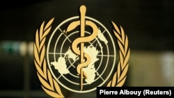 The World Health Organization (WHO) logo is pictured at the entrance of its headquarters in Geneva, January 25, 2015. REUTERS/Pierre Albouy