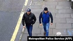 A handout picture taken in Salisbury on March 4, 2018, and released by the British Metropolitan Police Service in London on September 5, 2018, shows Alexander Petrov (R) and Ruslan Boshirov, who are wanted by British police.