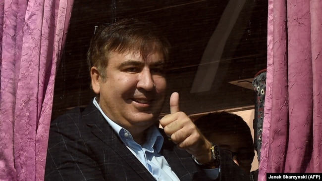 Saakashvili gestures as he sits in a bus leaving from Rzeszow, Poland, towards the Ukrainian border, September 10, 2017.
