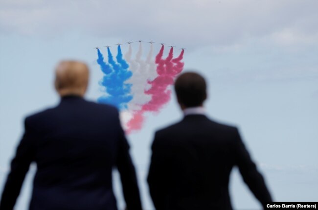 FRANCE -- U.S. President Donald Trump and French President Emmanuel Macron look to flypasts in the Normandy American Cemetery to commemorate the 75th anniversary of the D-Day landings, Normandy. June 6, 2019