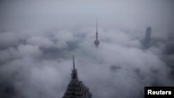 China -- Skyscrapers Oriental Pearl Tower and Jin Mao Tower (L) are seen from the Shanghai World Financial Center, in rain at the financial district of Pudong in Shanghai, January 28, 2016
