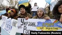 UKRAINE – Participants hold placards and shout slogans during an anti-war rally in the Crimean village of Eskisaray, outside Simferopol, March 10, 2014