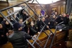 People protest against an agreement to halt fighting over the Nagorno-Karabakh region inside a government building in Yerevan, Armenia on November 10, 2020. AP