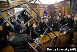 People protest against an agreement to halt fighting over the Nagorno-Karabakh region inside a government building in Yerevan, Armenia on November 10, 2020. AP