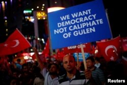 A man holds up a sign during a solidarity gathering in central Ankara on July 27, 2016. (Umit Bektas/Reuters)