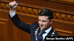 UKRAINE -- Ukrainian President Volodymyr Zelenskiy holds the presidential stamp during his inauguration ceremony at the parliament in Kyiv, May 20, 2019