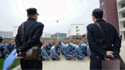 A photo taken in December 2018 shows guards monitoring Uyghur inmates at a reeducation camp in Xinjiang. (Bitter Winter)