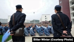 A photo taken in December 2018 shows guards monitoring Uyghur inmates at a reeducation camp in Xinjiang. (Bitter Winter)