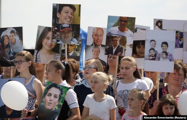 UKRAINE - People gather near a monument for the victims of the Malaysia Airlines flight MH17 plane crash to mark the fourth anniversary of the accident near the village of Hrabove (Grabovo) in Donetsk Region, Ukraine July 17, 2018.