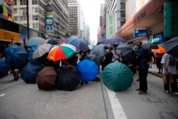 CHINA -- Protesters set up defense shield using umbrellas on a road in Mongkok, Hong Kong, Wednesday, May 27, 2020. Hong Kong Protests
