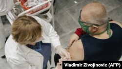 A man receives a Pfizer-BioNTech Covid-19 vaccine at a clinic in Belgrade, Serbia, January 13, 2021. 