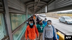 Migrants approach the U.S. border on Gateway International Bridge in Brownsville, Texas, on March 2, 2021.