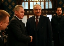 RUSSIA -- Commander of the Libyan National Army (LNA) Khalifa Haftar shakes hands with Russian Defense Minister Sergei Shoigu before talks in Moscow, January 13, 2020.