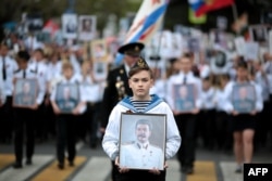Ukraine -- People carry portraits of late Soviet leader Josef Stalin and WWII soldiers during the Immortal Regiment march as they celebrate the 72nd anniversary of the Soviet Union's victory over Nazi Germany in WWII in Sevastopol, Crimea, May 9, 2017.