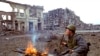 A Russian soldier lights a cigarette in the Chechen capital of Grozny, Sunday, in this March 19, 1995 file photo. (AP Photo/Shakh Aivazov, File)
