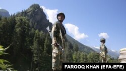 Indian paramilitary soldiers stand guard on a highway leading to Ladakh, India in the territory of Kashmir on June 17, 2020, two days after a bloody border clash with Chinese soldiers. 