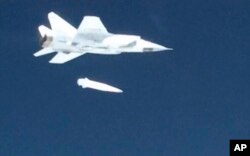 A Russian MiG-31 fighter jet releases the new Kinzhal (Dagger) hypersonic missile during a test in Russia.