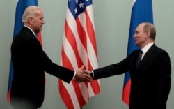 RUSSIA -- Russian Prime Minister Vladimir Putin shakes hands with U.S. Vice President Joe Biden during their meeting in Moscow, March 10, 2011.
