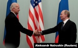 RUSSIA -- Russian Prime Minister Vladimir Putin shakes hands with U.S. Vice President Joe Biden during their meeting in Moscow, March 10, 2011.