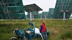 CHINA – A worker waits to replace mirrors on heliostats used for reflecting sunlight at the Yanqing Solar Thermal Power Generation Base in Yanqing, north of Beijing, on Sept. 28, 2020.